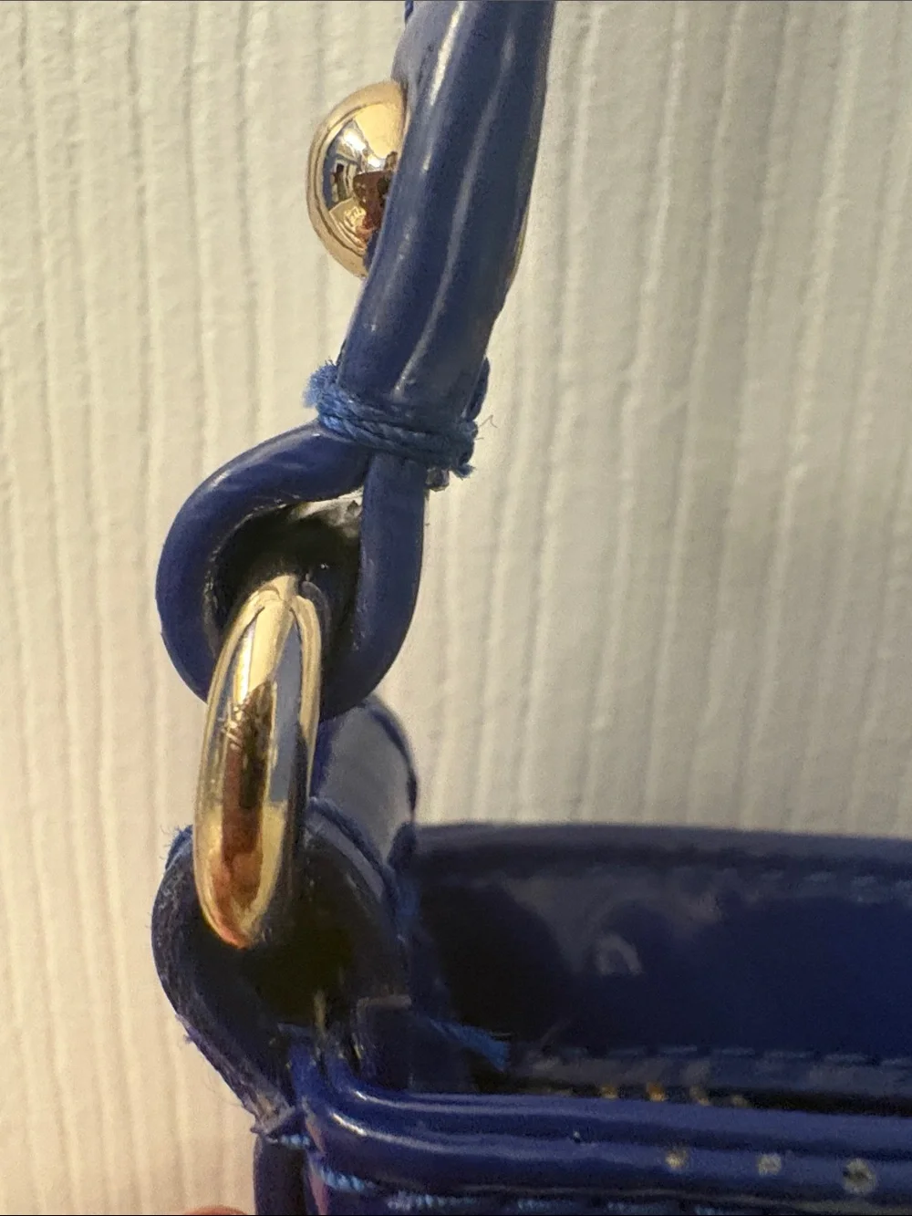 Kate Spade heart perforated patent leather crossbody in cobalt blue.